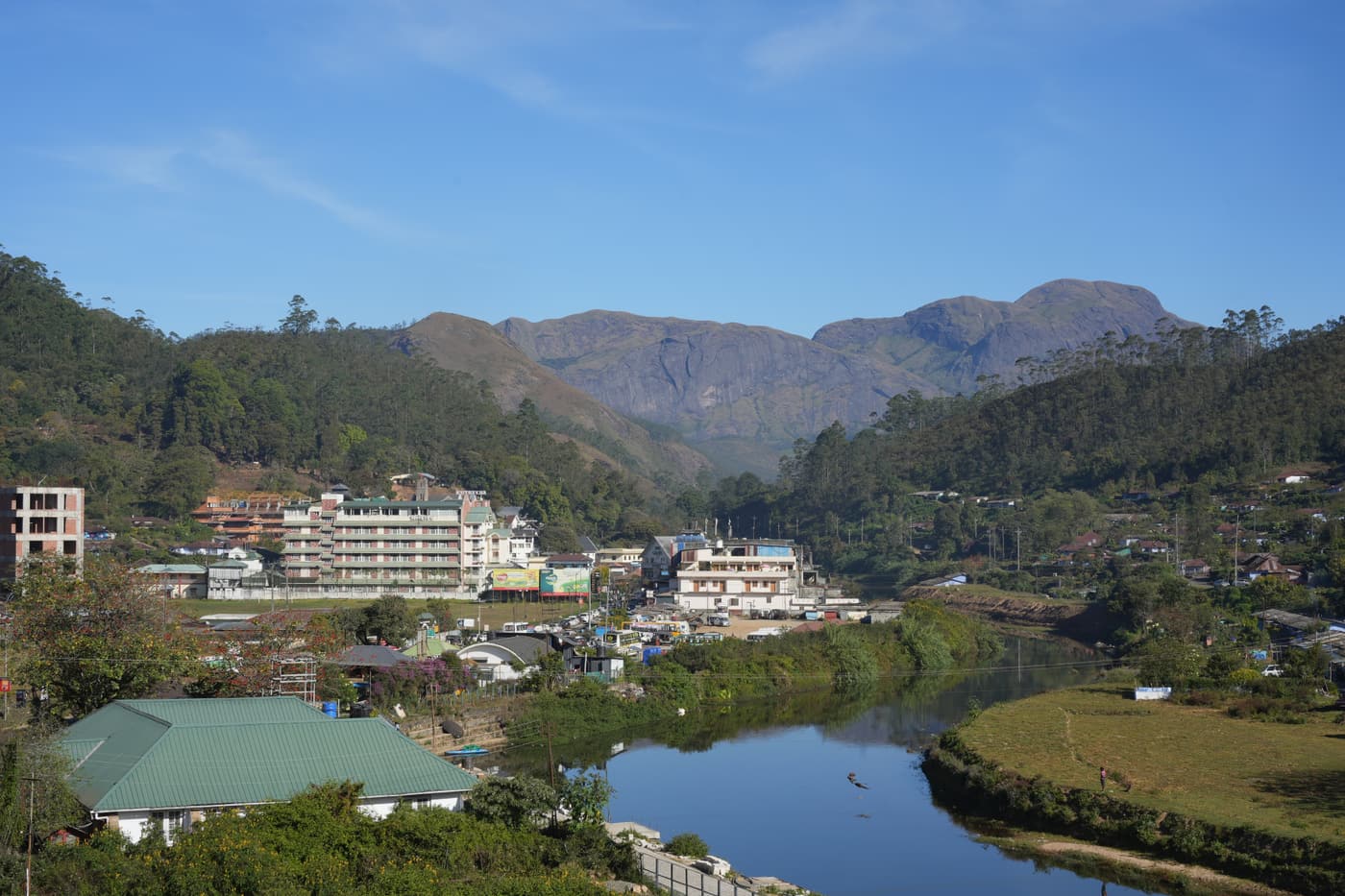 Munnar town beside its river, with hotels and tea hills behind